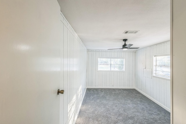 carpeted spare room with ceiling fan