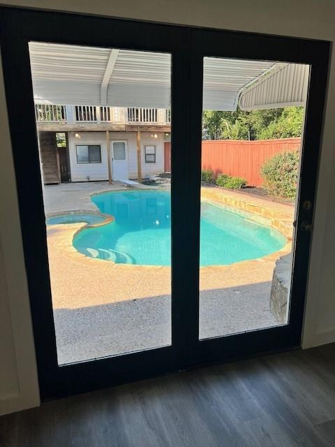 view of pool featuring french doors