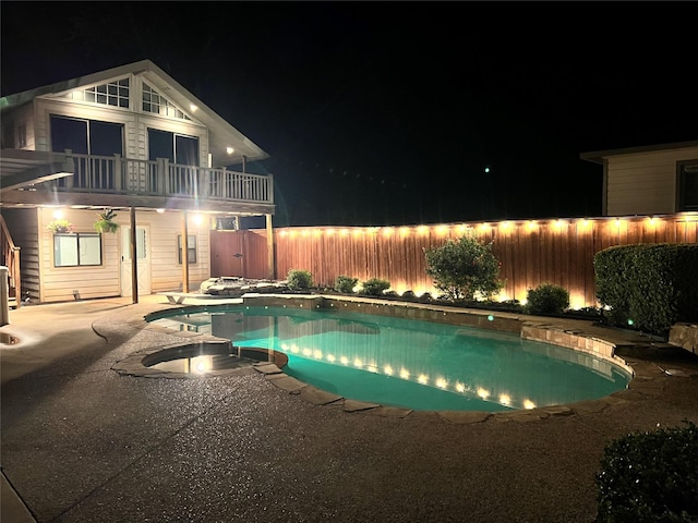 pool at night with a patio