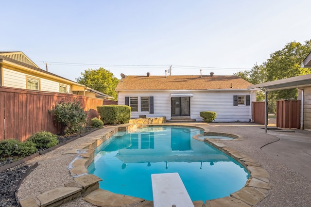 view of pool featuring a diving board