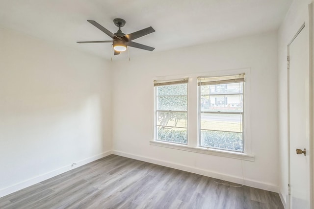 spare room featuring ceiling fan and light wood-type flooring