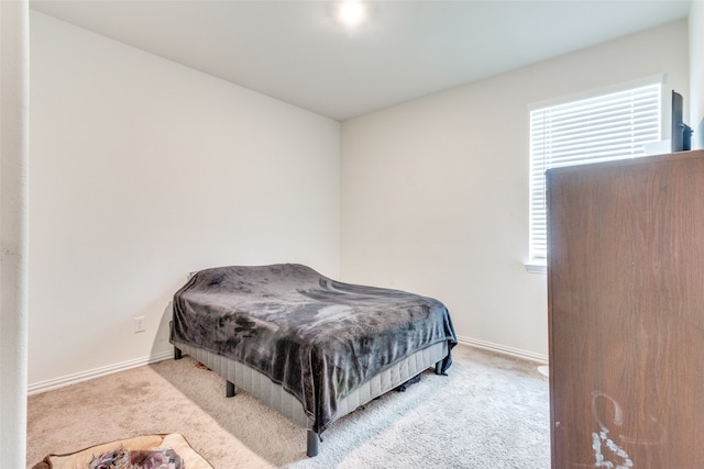 bedroom featuring light carpet