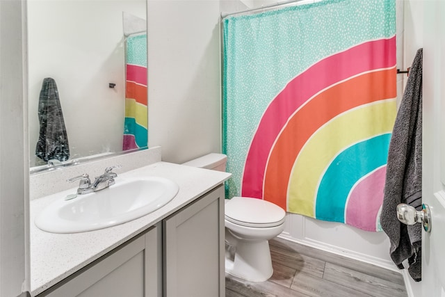 bathroom featuring hardwood / wood-style flooring, vanity, and toilet