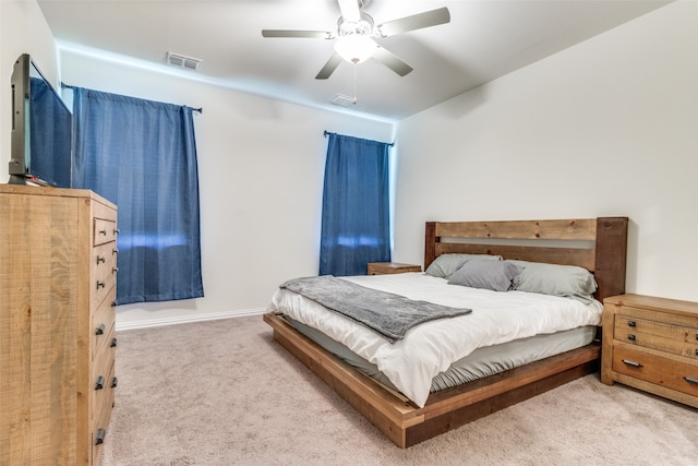 bedroom featuring ceiling fan and light carpet