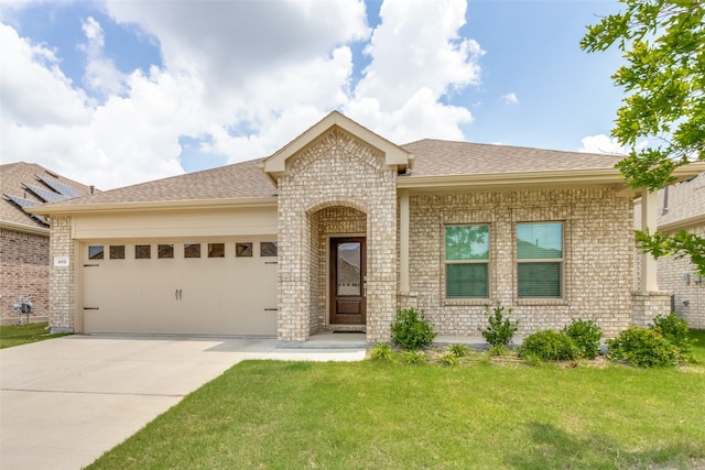 view of front of house with a garage and a front lawn