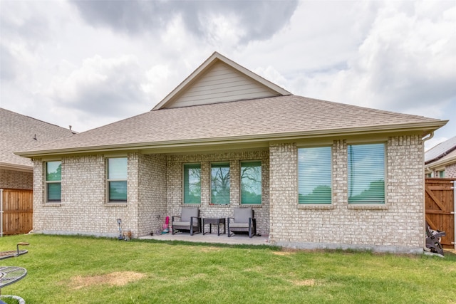 back of house with a lawn and a patio area