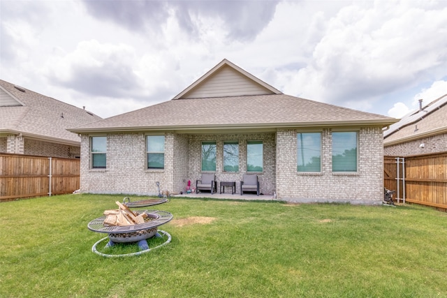 rear view of property with a lawn and a patio area