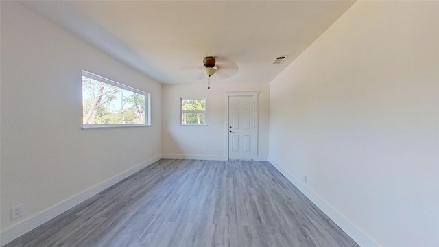 unfurnished room featuring ceiling fan and hardwood / wood-style floors