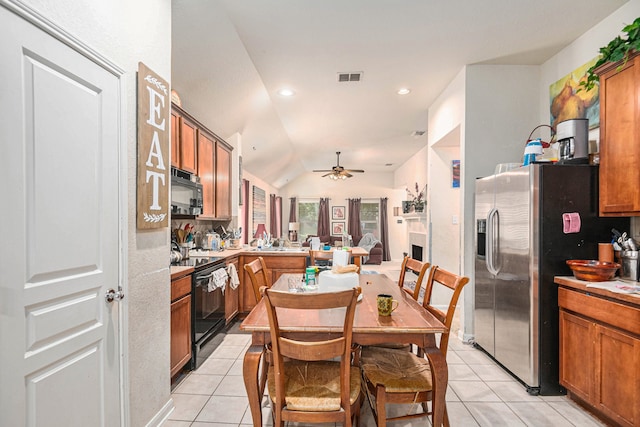 kitchen featuring ceiling fan, light tile patterned floors, vaulted ceiling, black appliances, and sink