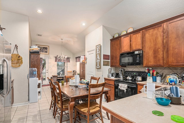 kitchen with black appliances, vaulted ceiling, decorative backsplash, light tile patterned floors, and a chandelier