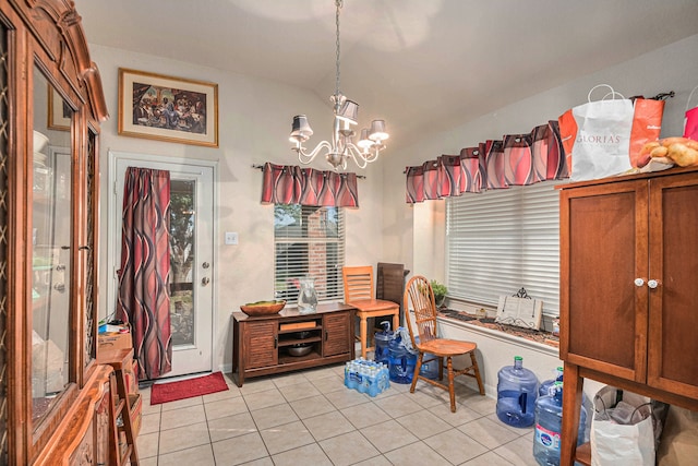 sitting room with an inviting chandelier, light tile patterned floors, and vaulted ceiling