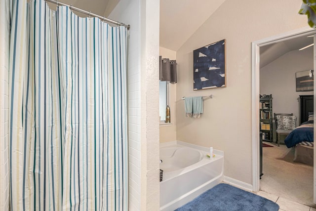 bathroom featuring lofted ceiling, shower with separate bathtub, and tile patterned floors