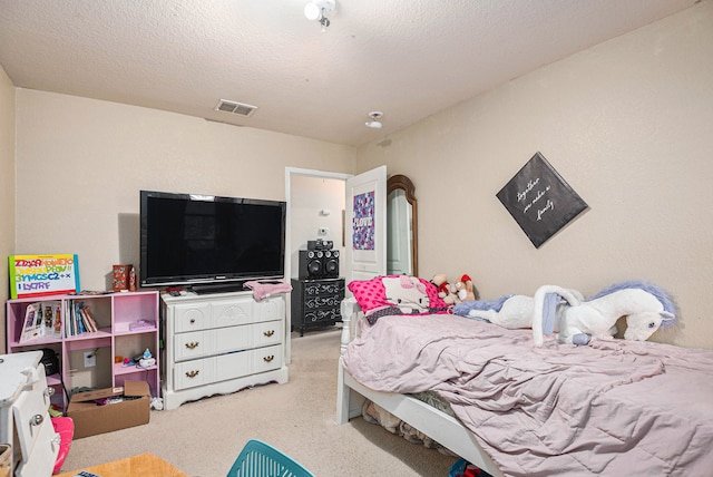 bedroom featuring light carpet and a textured ceiling