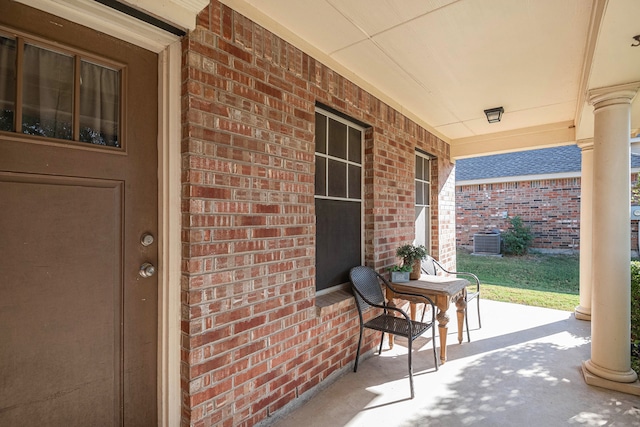 view of patio with cooling unit and a porch