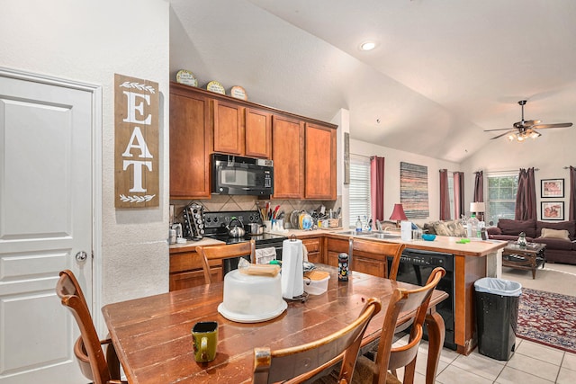 kitchen with black appliances, sink, ceiling fan, lofted ceiling, and light tile patterned floors