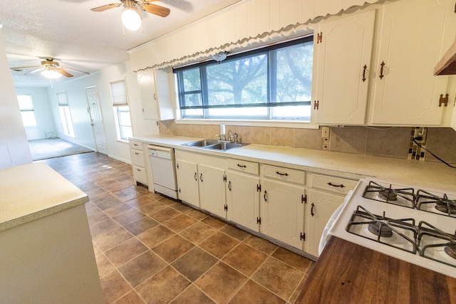 kitchen with white appliances, sink, backsplash, white cabinets, and a textured ceiling