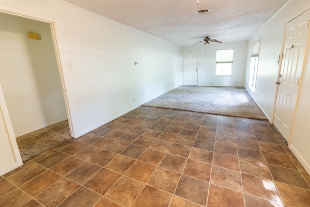 carpeted empty room with a textured ceiling and ceiling fan