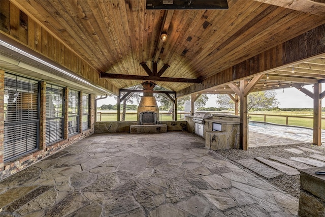 view of patio / terrace featuring area for grilling and an outdoor fireplace