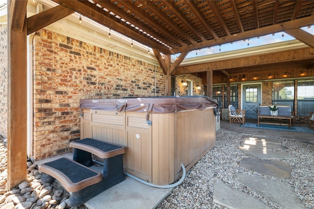 view of patio / terrace with a hot tub