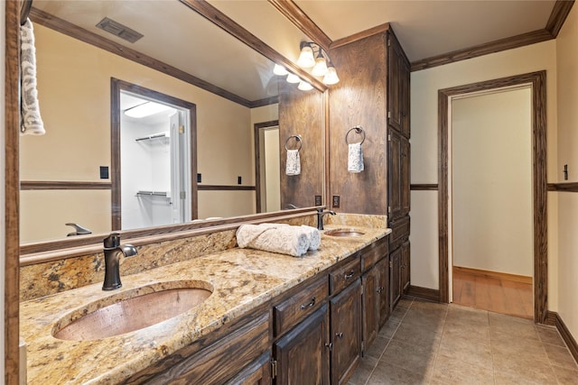 bathroom featuring vanity, tile patterned floors, and crown molding