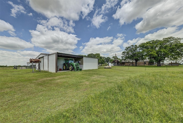 view of yard featuring an outbuilding and a rural view