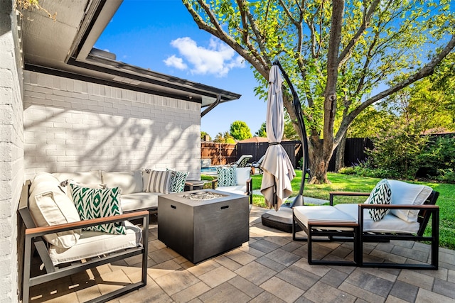 view of patio / terrace featuring an outdoor living space with a fire pit