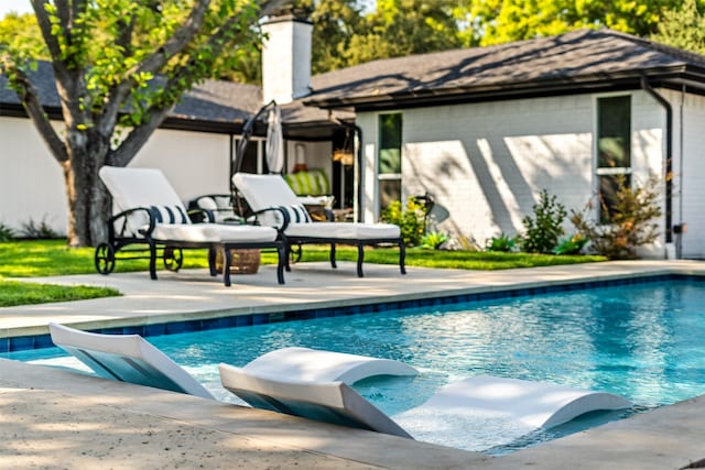 view of swimming pool with a patio