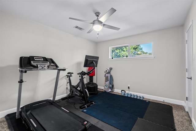 exercise area with ceiling fan and carpet