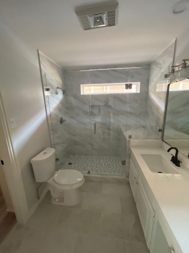 bathroom with tile patterned flooring, toilet, walk in shower, and vanity