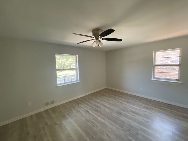 spare room with ceiling fan and light hardwood / wood-style floors