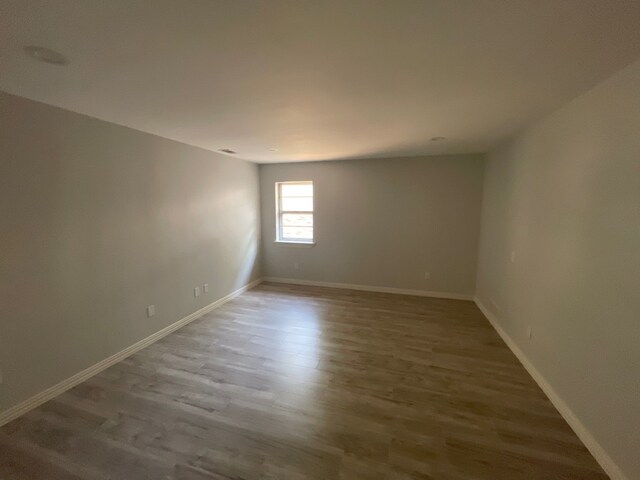 empty room featuring hardwood / wood-style flooring