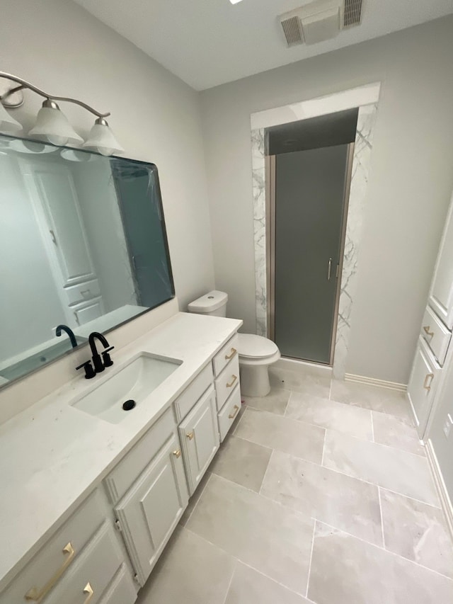 bathroom with toilet, tile patterned flooring, and vanity