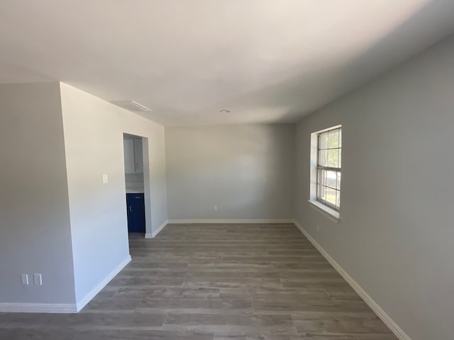 spare room with dark hardwood / wood-style floors