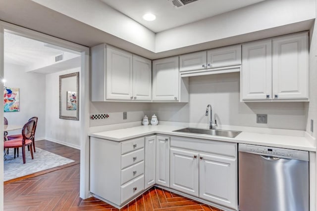 kitchen featuring light countertops, stainless steel dishwasher, white cabinetry, and a sink