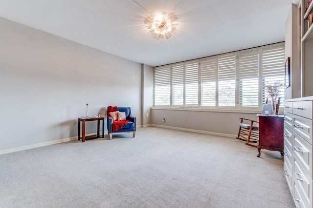 living area with light colored carpet and baseboards