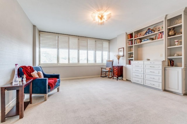 living area with light carpet and baseboards
