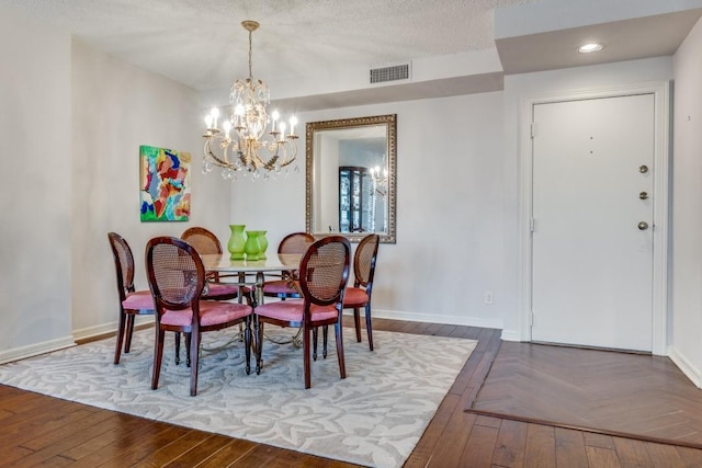 dining space featuring parquet flooring, an inviting chandelier, baseboards, visible vents, and recessed lighting