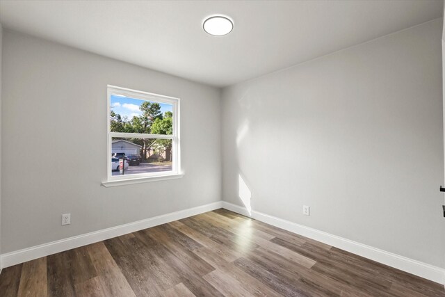 unfurnished room featuring plenty of natural light, hardwood / wood-style floors, and ceiling fan