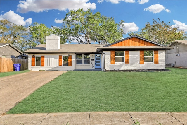 single story home with a front yard and central AC unit