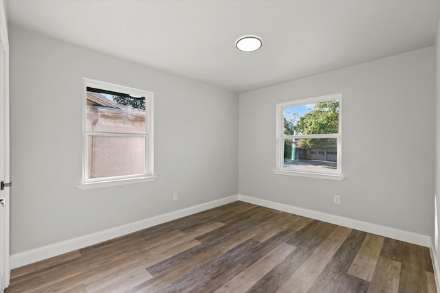 unfurnished room with hardwood / wood-style flooring