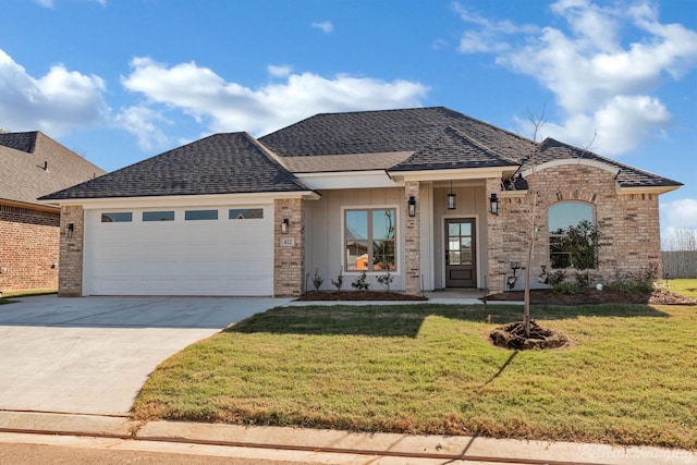 view of front of home featuring a front lawn and a garage