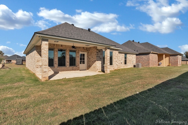 rear view of house with a yard, ceiling fan, and a patio area