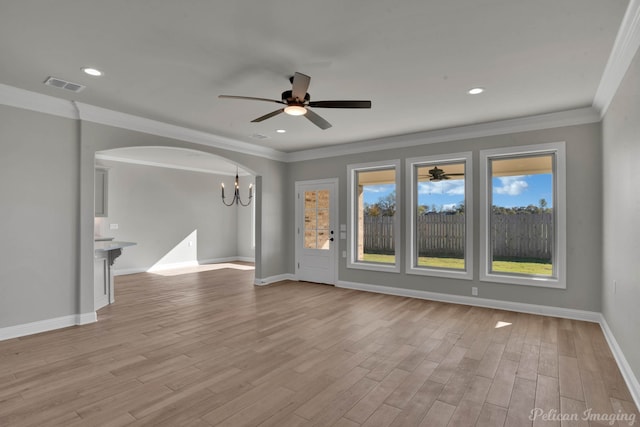 unfurnished living room featuring ceiling fan with notable chandelier, light hardwood / wood-style flooring, and ornamental molding