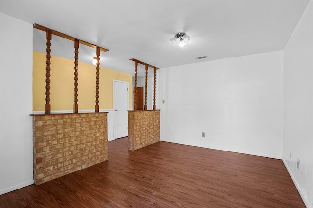 unfurnished living room featuring dark hardwood / wood-style floors