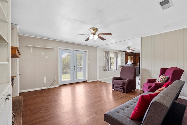 living room with ceiling fan, french doors, and dark hardwood / wood-style floors