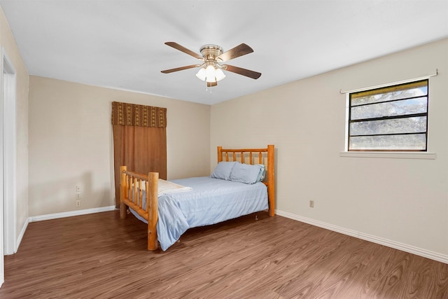 bedroom with wood-type flooring and ceiling fan