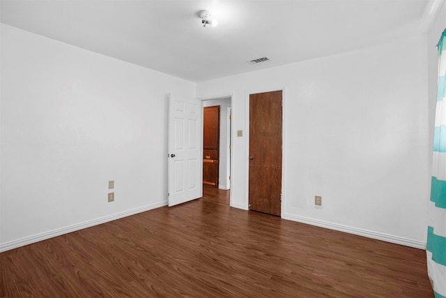 spare room with dark wood-type flooring