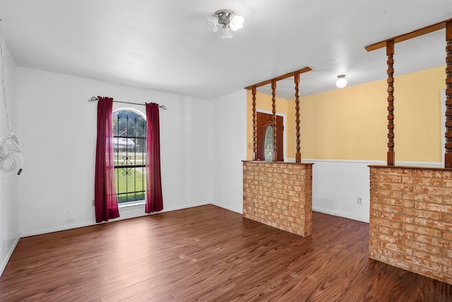 unfurnished living room featuring dark wood-type flooring