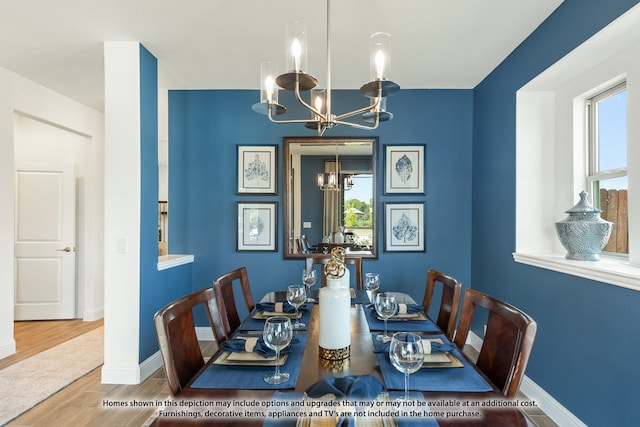 dining area featuring wood-type flooring and a notable chandelier