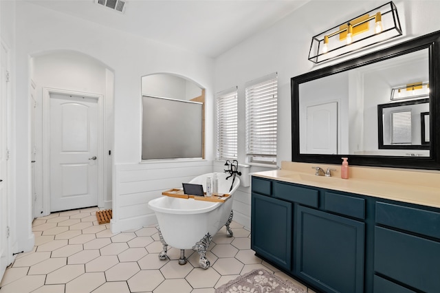 bathroom with vanity, plus walk in shower, and tile patterned floors